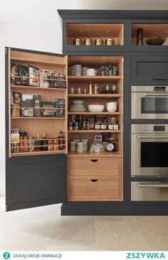 an open pantry with lots of food and spices in the cupboards next to it