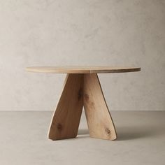 a wooden table sitting on top of a white floor