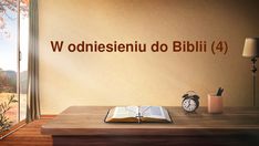 an open book sitting on top of a wooden table next to a lamp and window