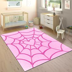 a baby's room with a pink rug and crib