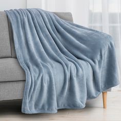 a couch with a blue blanket on top of it