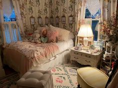 a bedroom with floral wallpaper and teddy bears on the bed