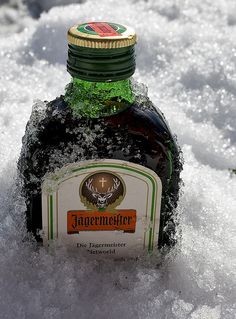 a bottle of jagermeister in the snow