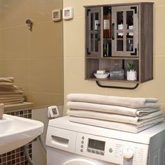 a washer and dryer in a bathroom with towels stacked on top of each other