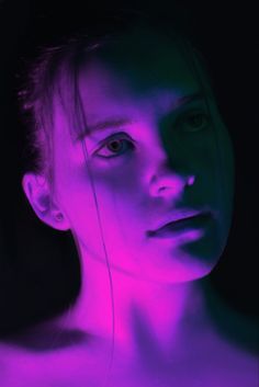 a woman with purple light on her face