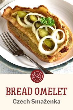 a white plate topped with a piece of bread covered in toppings