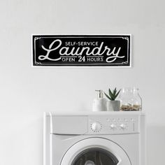 there is a laundry sign above the washer