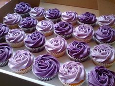 cupcakes with pink frosting in a box