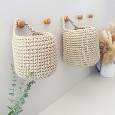 two baskets are hanging on the wall