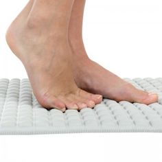 a person standing on top of a mattress with their feet propped against the padding