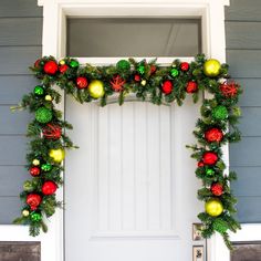 a christmas wreath on the front door of a house