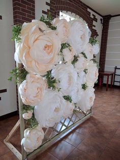 a bunch of flowers that are sitting on a stand in a room with tile flooring