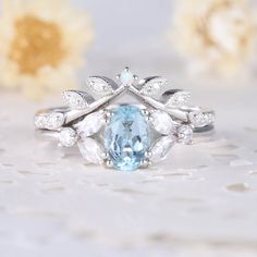 a blue and white ring sitting on top of a table next to some yellow flowers