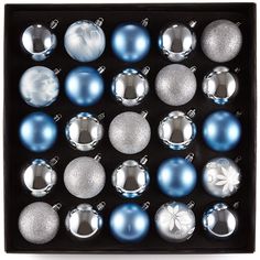 an assortment of christmas ornaments in a black box with silver and blue baubles