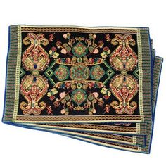 three placemats with an ornate design on the top and bottom, one in blue