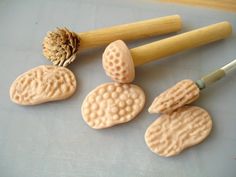 some cookies are sitting on a table next to a rolling pin and a pine cone