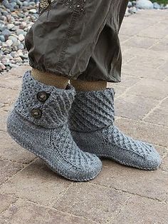 a person wearing gray knitted boots and pants