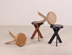 three wooden stools sitting next to each other