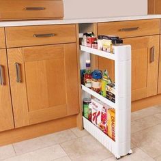 an open refrigerator door in a kitchen with wooden cabinets and white counter top, filled with food