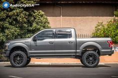 a gray truck parked in front of a building