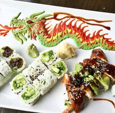 sushi is served on a white plate with sauce and garnish