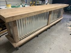 a large wooden table with metal bars on it's sides in a workshop area