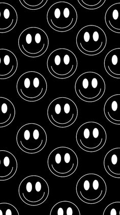 a black and white pattern with circles in the shape of smiley faces on a black background