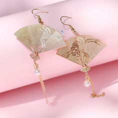 These cool unique metal fan tassel dangle drop earrings features a metal fan that can fold open and close dangle drop with a long metal chain and pearl accents. These big fan drop earrings will make a statement and will elevate your party outfit. Add these Japanese style fan drop earrings to your everyday fashion jewelry collection or as gift for your love one. Jewelry Care: See more information about how to care for your jewelry here. Shipping Policy: Orders will be shipped within 1-3 business Victorian Christmas Dress, Metal Fan, Folding Fan, Victorian Christmas, Christmas Dress, Metal Chain, Japanese Style, Jewelry Care, Party Outfit