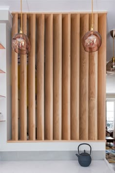 two hanging lights in the middle of a room with wood paneling on the wall