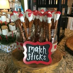 there is a sign that says match sticks in front of some cookies and marshmallows