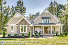 a large house with lots of windows in the front yard and trees on both sides