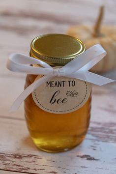 a jar filled with honey sitting on top of a wooden table