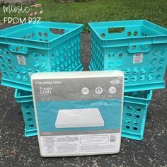 three blue plastic baskets sitting next to each other on the ground in front of some grass