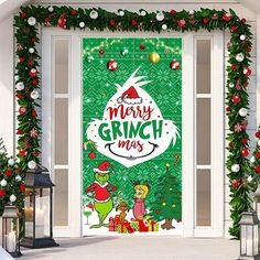 the grinch christmas door cover is decorated with holly garlands and holiday decorations, along with lanterns