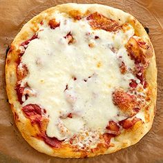 a pizza sitting on top of a wooden cutting board