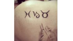 the word xo written in black ink on top of a person's back