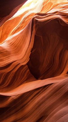 the sun shines on an abstractly colored rock formation