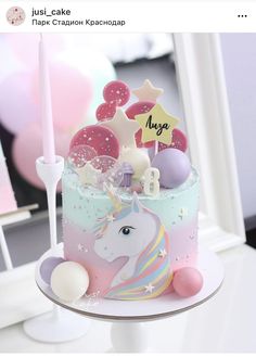 a unicorn themed birthday cake with candles and decorations