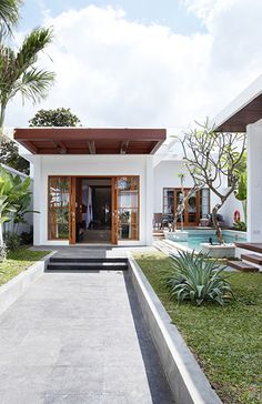 a white house with a pool in the yard