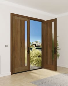 an open wooden door in a white room with wood flooring and large glass doors