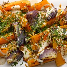 a white plate topped with carrots, onions and parsley on top of it