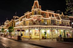 an old fashioned building is lit up at night