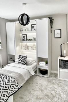 a bedroom with white furniture and black accents