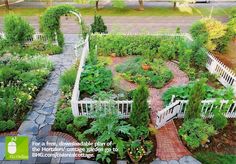 an aerial view of a garden with white picket fence