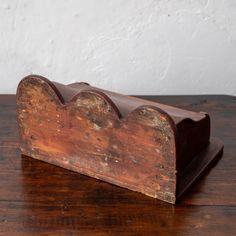 an old wooden object on a wood table