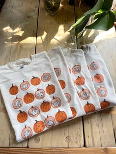 Hand Printed and Hand Drawn! This is a 100% cotton screen printed t shirt with a hand drawn illustration showing the inside and outside of pumpkins.  It's perfect for fall!  The shirt shown here is Natural and printed in orange and brown ink.  // PROCESS:  All of our items are individually hand printed by either me or my dad, which can lead to slight variations in placement.  The ink is heat cured and will not fade over time.   Since our items are printed to order, there is a 1-2 week processing Printed Cotton T-shirt For Fall, Fall Printed Cotton T-shirt, Fall Cotton Printed T-shirt, Orange Screen Print T-shirt For Fall, Screen Print Shirt, Screen Printing Shirts, Foodie Gifts, Clothes Gift, Print Shirt