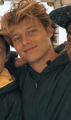 two young boys sitting next to each other in the back seat of a car together