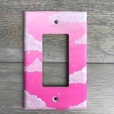 a pink and white painted light switch plate