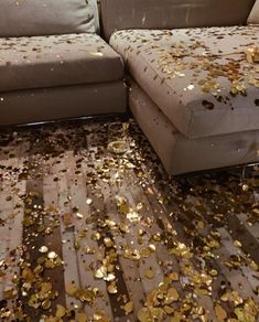 the floor is covered with gold confetti as it sits next to a couch