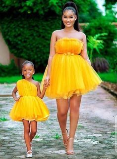 a mother and daughter wearing yellow dresses